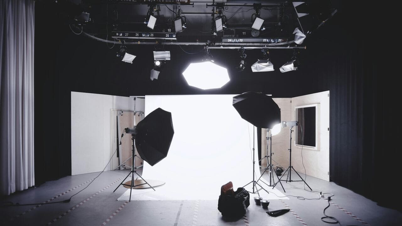 Photography studio with softboxes and a white backdrop