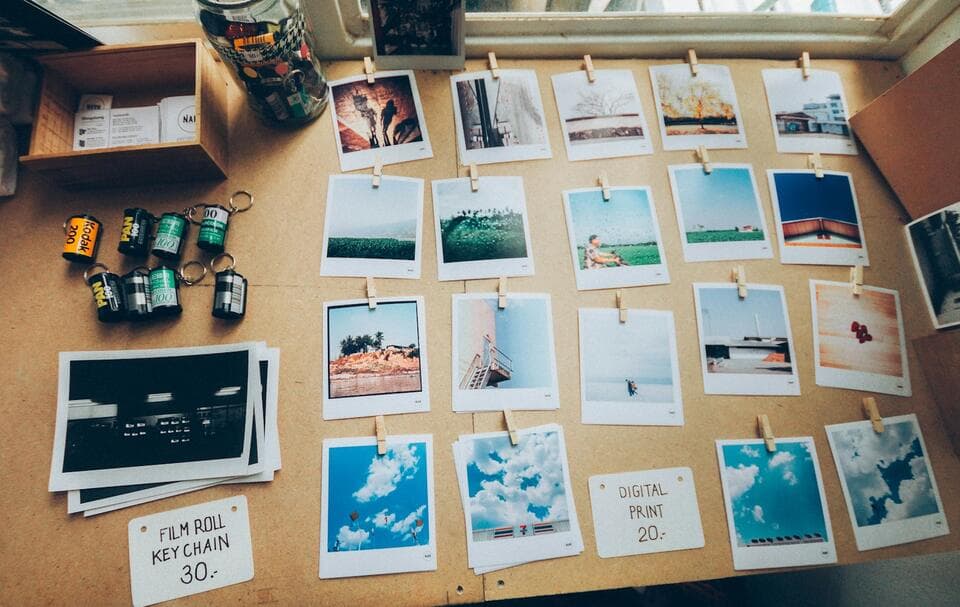 Instant photos pinned to a cork board